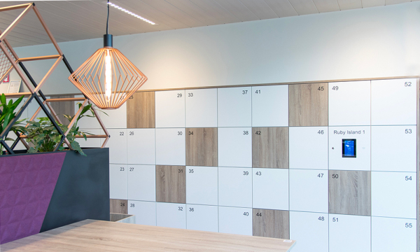 Lockers with white and wooden doors that are numbered, and equipped with a smart locker system 