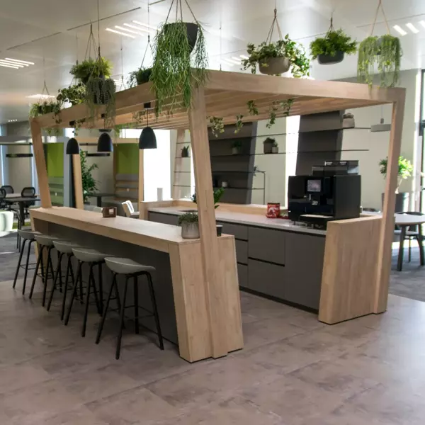 Wooden coffee corner with bar stools and plants